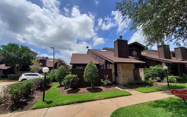 2611 Grants Lake Blvd Unit 228, Sugar Land, TX 77479 - view of home's exterior with a chimney