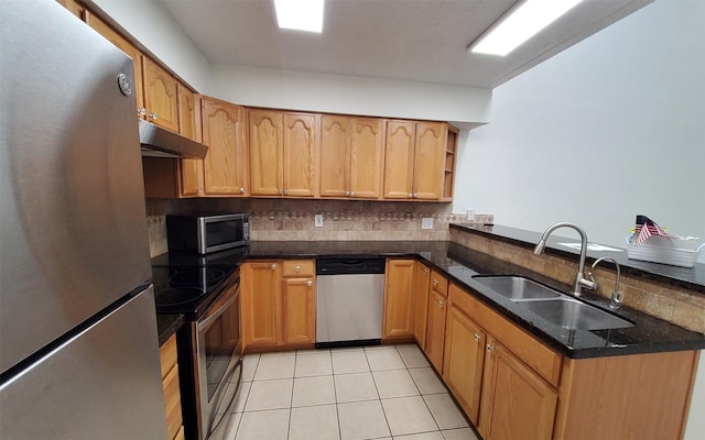 2611 Grants Lake Blvd Unit 228, Sugar Land, TX 77479 - kitchen featuring appliances with stainless steel finishes, a sink, backsplash, under cabinet range hood, and light tile patterned floors