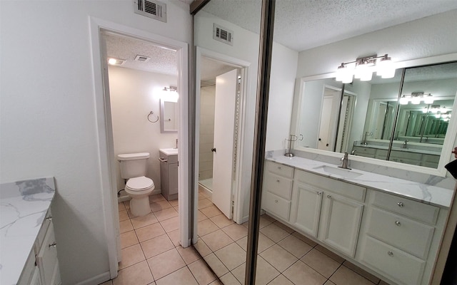 2611 Grants Lake Blvd Unit 228, Sugar Land, TX 77479 - full bath featuring a textured ceiling, vanity, and tile patterned floors