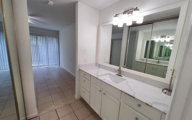 2611 Grants Lake Blvd Unit 228, Sugar Land, TX 77479 - bathroom featuring tile patterned floors, vanity, and a textured ceiling