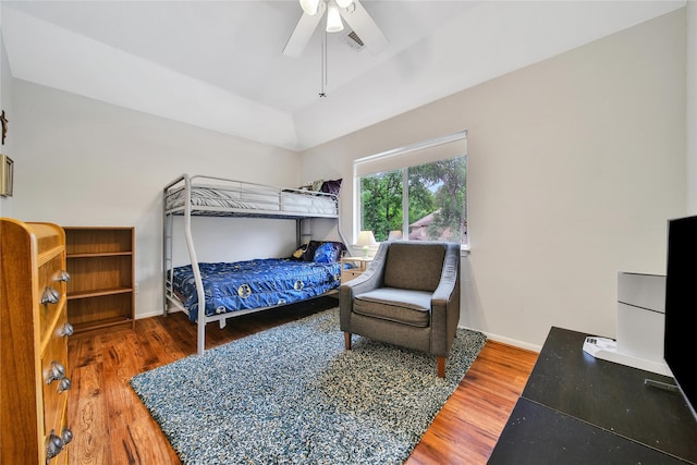 bedroom with visible vents, baseboards, ceiling fan, and wood finished floors