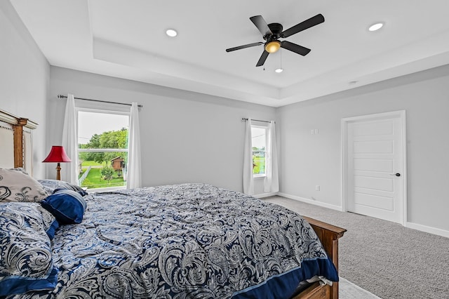 3409 2nd Ave N, Texas City, TX 77590 - carpeted bedroom featuring recessed lighting, a tray ceiling, and multiple windows