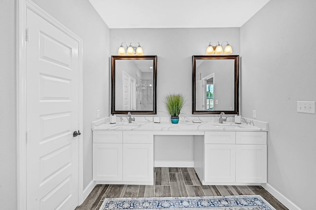 3409 2nd Ave N, Texas City, TX 77590 - full bathroom with double vanity, a sink, and wood finished floors