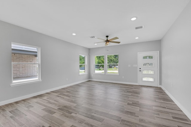 3409 2nd Ave N, Texas City, TX 77590 - unfurnished living room featuring ceiling fan, recessed lighting, baseboards, wood finished floors, and visible vents