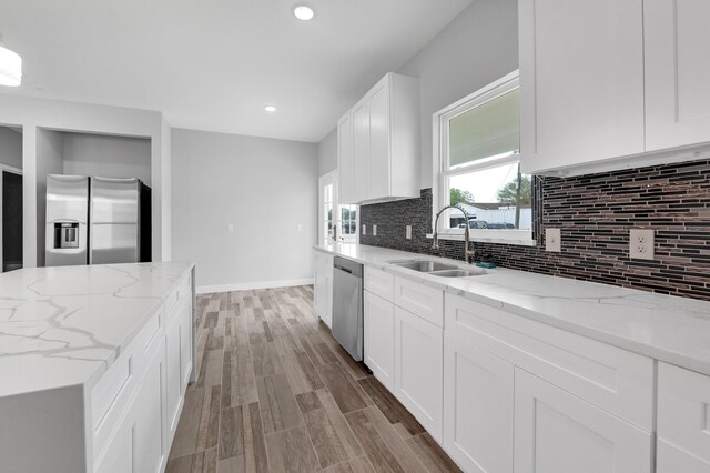 3409 2nd Ave N, Texas City, TX 77590 - kitchen featuring a sink, appliances with stainless steel finishes, tasteful backsplash, and wood finished floors