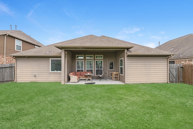 rear view of property featuring a fenced backyard, a yard, and a patio area