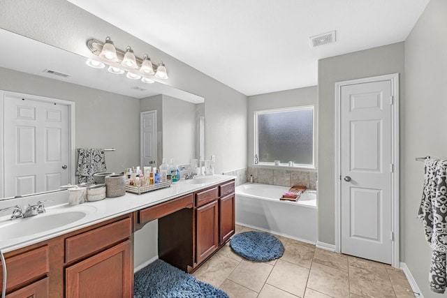 bathroom featuring double vanity, visible vents, a sink, and a garden tub