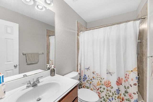 bathroom featuring vanity, toilet, and a shower with shower curtain