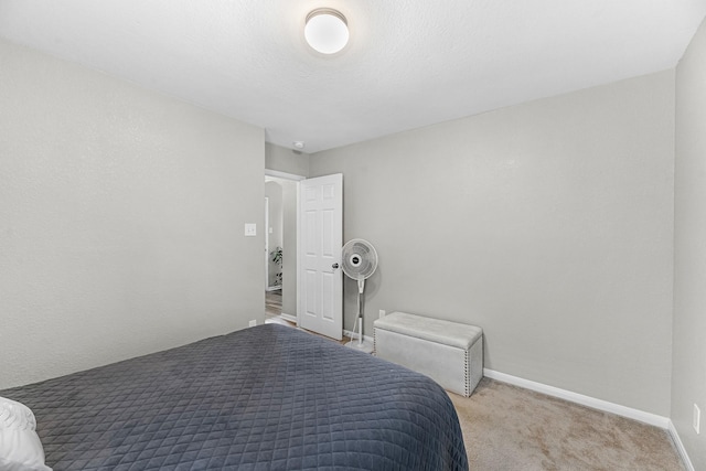 bedroom featuring baseboards and light colored carpet
