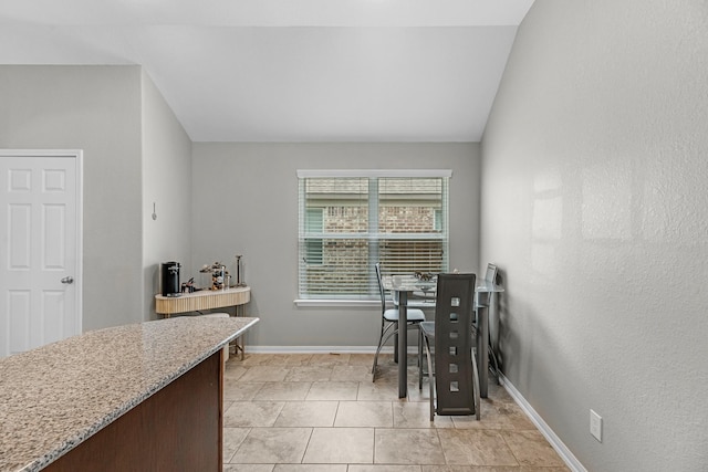 dining space with light tile patterned flooring and baseboards