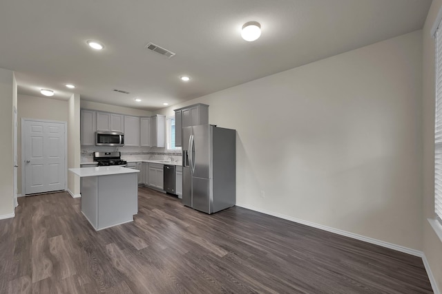 4202 Amber Ruse Dr, Conroe, TX 77304 - kitchen with dark wood-style floors, visible vents, appliances with stainless steel finishes, and gray cabinetry