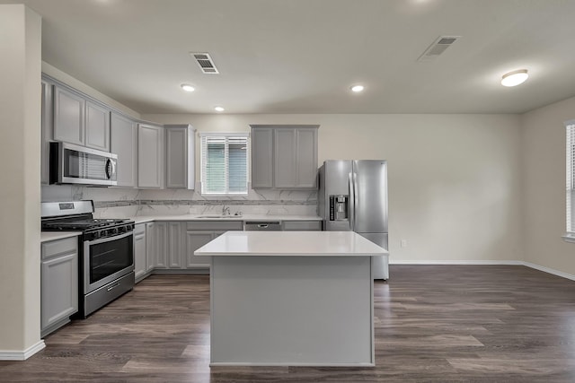 4202 Amber Ruse Dr, Conroe, TX 77304 - kitchen with a center island, gray cabinets, stainless steel appliances, and visible vents