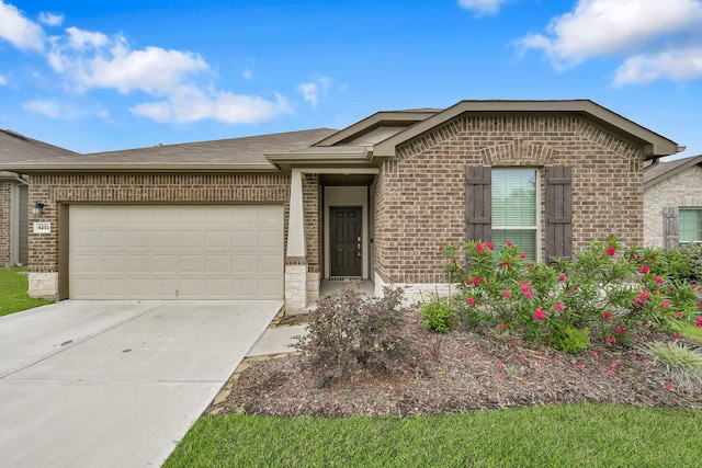 4202 Amber Ruse Dr, Conroe, TX 77304 - ranch-style house featuring driveway, roof with shingles, brick siding, and a garage