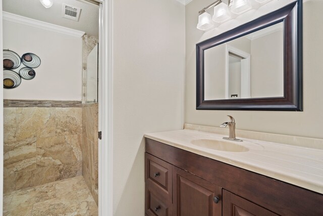 28710 Sapphire Cir, Magnolia, TX 77355 - bathroom featuring ornamental molding, tiled shower, and vanity