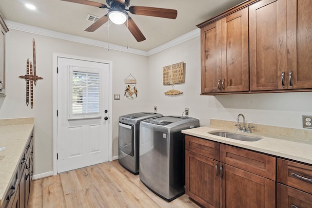 28710 Sapphire Cir, Magnolia, TX 77355 - clothes washing area featuring separate washer and dryer, light wood finished floors, cabinet space, ornamental molding, and ceiling fan