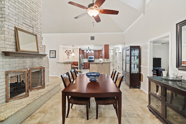 28710 Sapphire Cir, Magnolia, TX 77355 - dining area with high vaulted ceiling, a brick fireplace, a ceiling fan, a chandelier, and light tile patterned floors