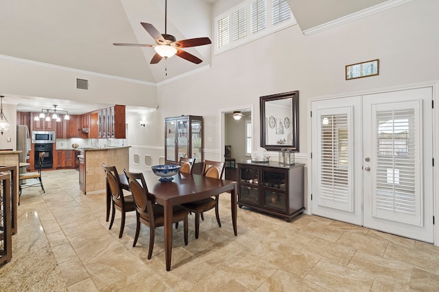 28710 Sapphire Cir, Magnolia, TX 77355 - dining area featuring a ceiling fan, a towering ceiling, french doors, plenty of natural light, and crown molding