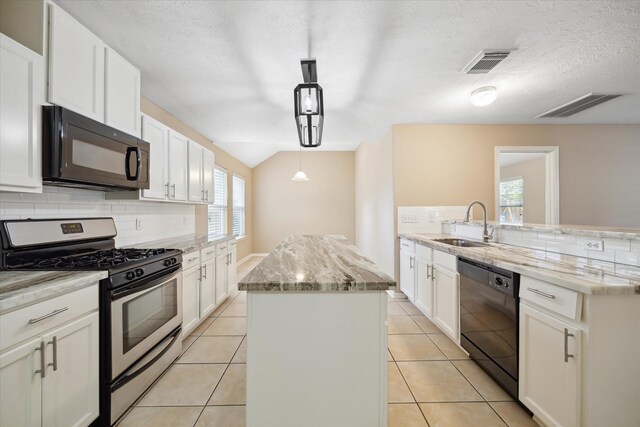2411 Lacyberry St, Houston, TX 77080 - kitchen with black appliances, a kitchen island, a sink, and decorative backsplash
