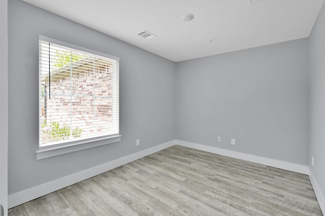 12390 Green Ridge Dr, Willis, TX 77318 - unfurnished room featuring baseboards, visible vents, and wood finished floors