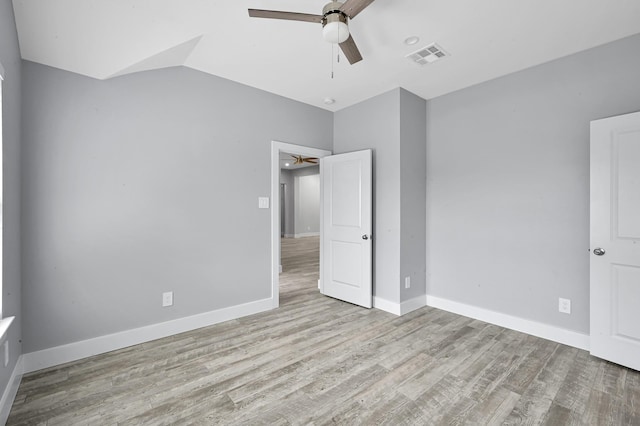 12390 Green Ridge Dr, Willis, TX 77318 - unfurnished bedroom featuring ceiling fan, baseboards, visible vents, and wood finished floors