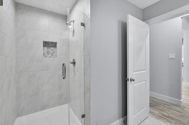 12390 Green Ridge Dr, Willis, TX 77318 - bathroom with baseboards, a shower stall, and wood finished floors