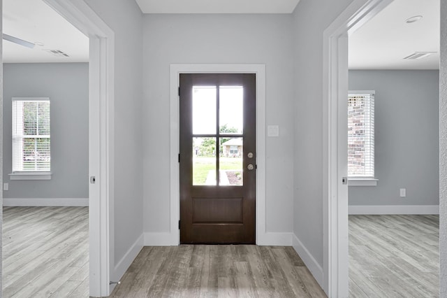 12390 Green Ridge Dr, Willis, TX 77318 - entrance foyer with baseboards, wood finished floors, and visible vents