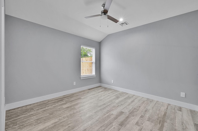 12390 Green Ridge Dr, Willis, TX 77318 - unfurnished room with visible vents, lofted ceiling, baseboards, ceiling fan, and light wood finished floors