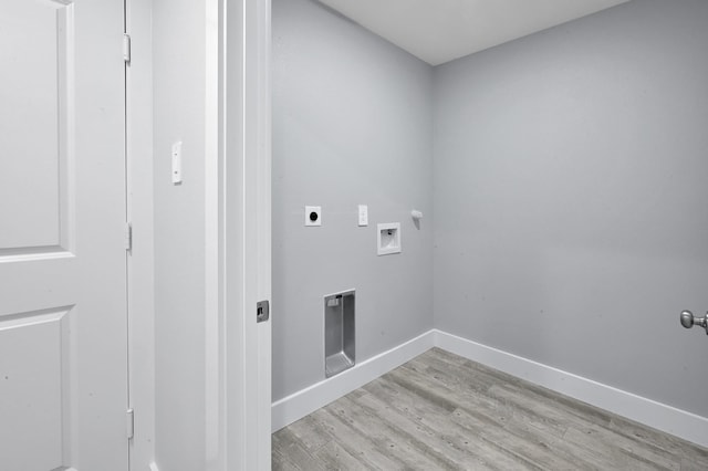 12390 Green Ridge Dr, Willis, TX 77318 - clothes washing area with washer hookup, laundry area, baseboards, light wood-type flooring, and hookup for an electric dryer