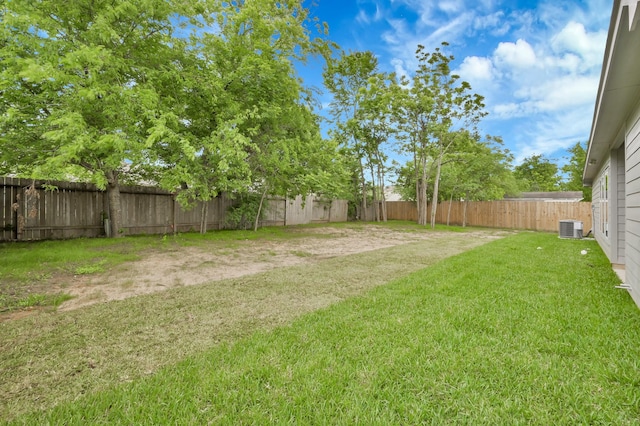 12390 Green Ridge Dr, Willis, TX 77318 - view of yard with cooling unit and a fenced backyard
