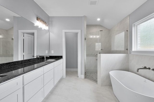 12390 Green Ridge Dr, Willis, TX 77318 - full bathroom with vanity, a soaking tub, a stall shower, and visible vents