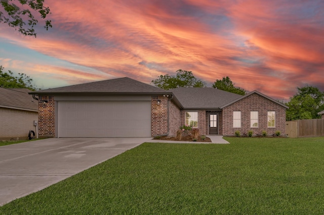 12390 Green Ridge Dr, Willis, TX 77318 - ranch-style house featuring brick siding, an attached garage, driveway, and a front lawn