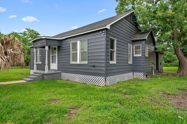 view of property exterior with a yard and crawl space