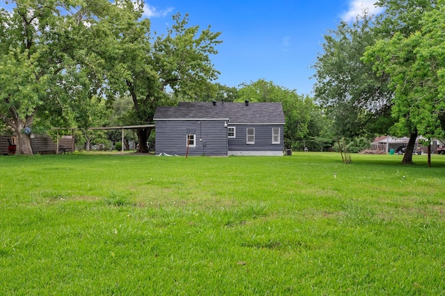 rear view of house featuring a yard