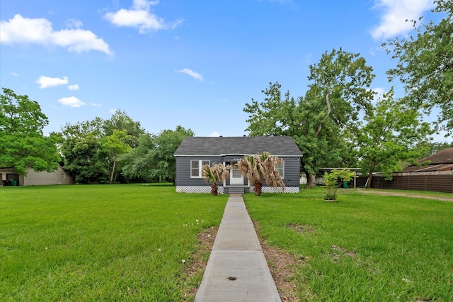bungalow-style home featuring fence and a front yard