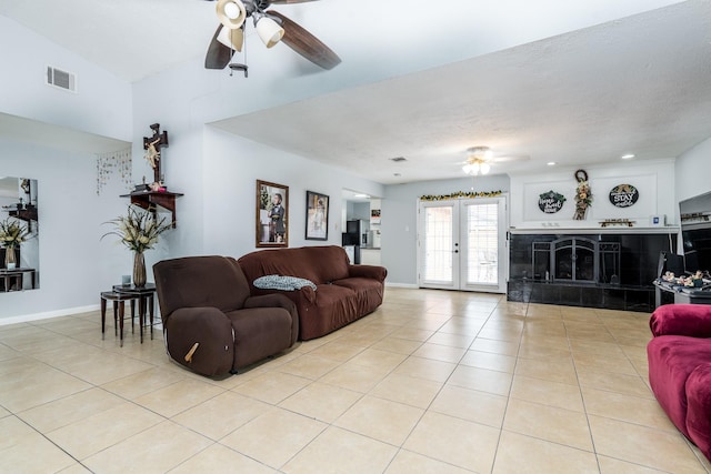 living area with baseboards, ceiling fan, light tile patterned flooring, and visible vents