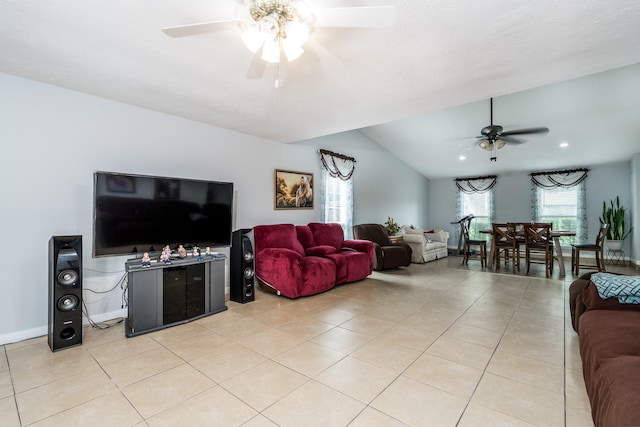 living room featuring light tile patterned flooring, ceiling fan, and lofted ceiling