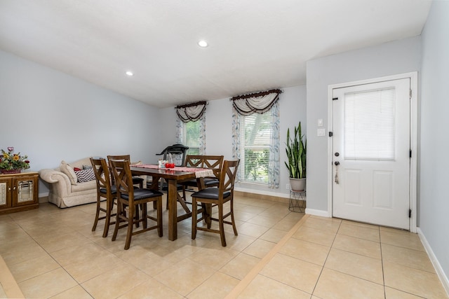 dining space featuring light tile patterned floors, baseboards, and recessed lighting