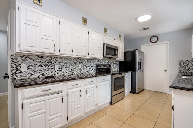kitchen with visible vents, backsplash, white cabinets, and stainless steel appliances