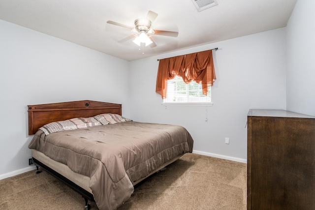 carpeted bedroom featuring visible vents, baseboards, and ceiling fan