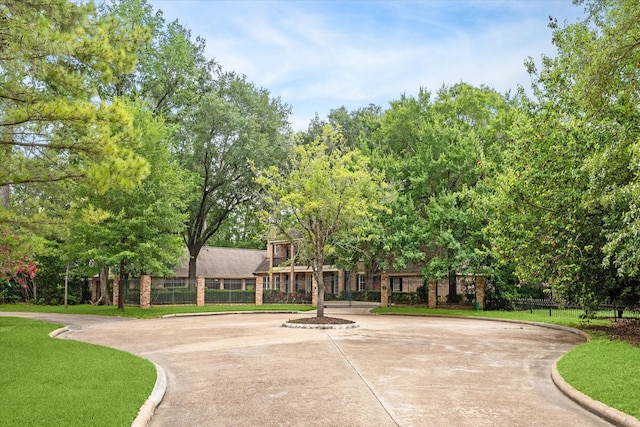 view of home's community featuring fence