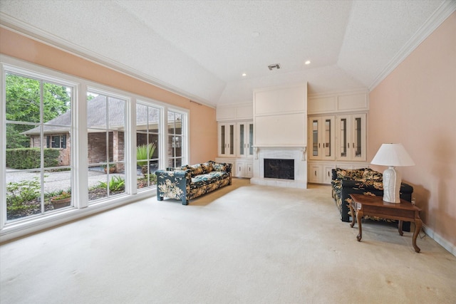 living area featuring crown molding, light colored carpet, a fireplace with raised hearth, vaulted ceiling, and visible vents