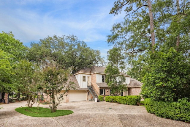 view of front of property with a garage, driveway, and brick siding