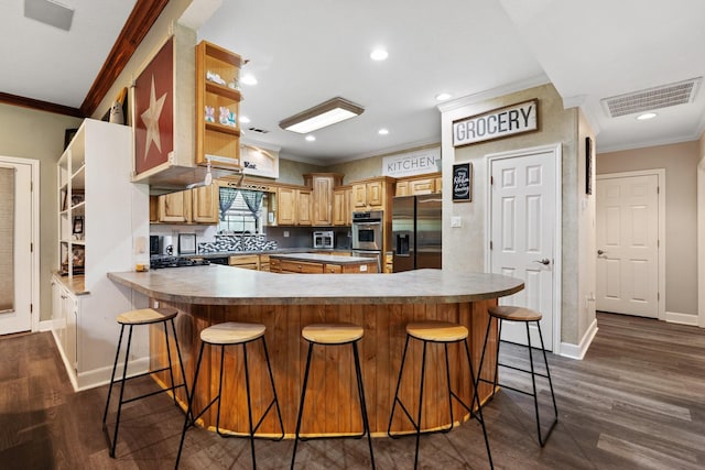 kitchen featuring visible vents, dark wood finished floors, baseboards, refrigerator with ice dispenser, and ornamental molding