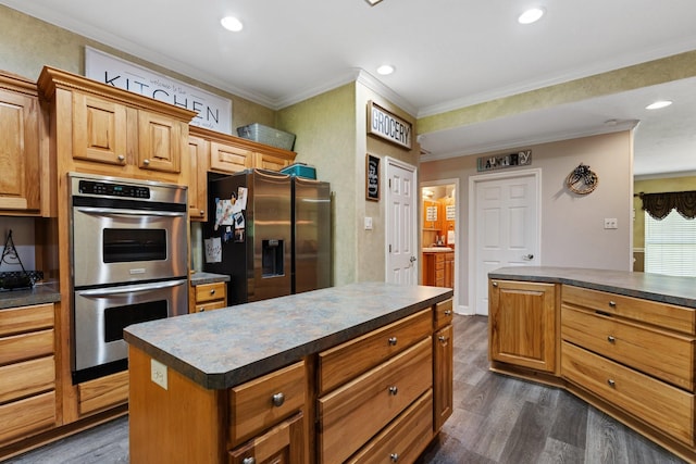 kitchen with recessed lighting, dark countertops, appliances with stainless steel finishes, and dark wood-style floors