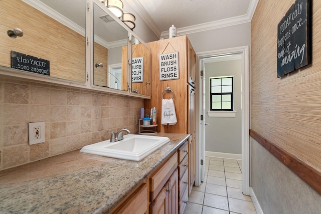 bathroom with backsplash, baseboards, crown molding, and tile patterned flooring