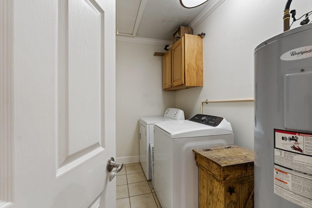 laundry room featuring washing machine and dryer, attic access, electric water heater, cabinet space, and light tile patterned floors