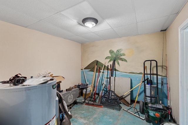 miscellaneous room with water heater and a drop ceiling
