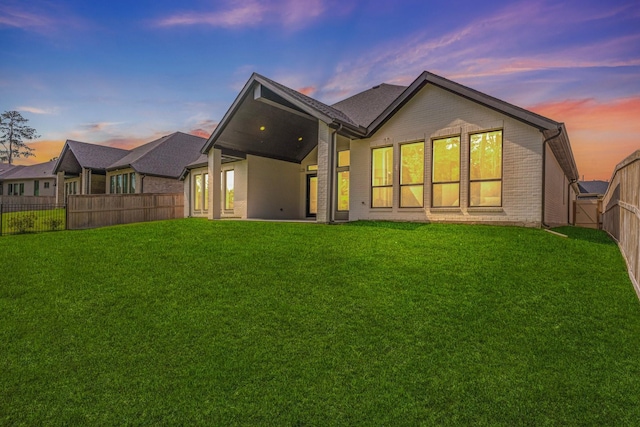 15631 Audubon Park Dr, Magnolia, TX 77354 - back of property at dusk with brick siding