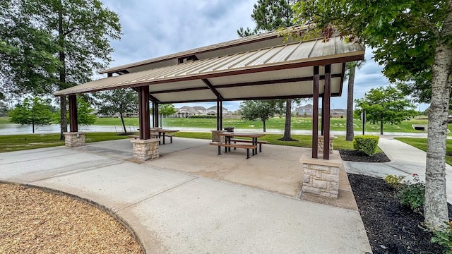 view of home's community with a gazebo, a lawn, and a water view