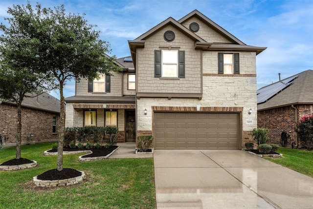 traditional-style home featuring stone siding, a front lawn, concrete driveway, an attached garage, and roof mounted solar panels